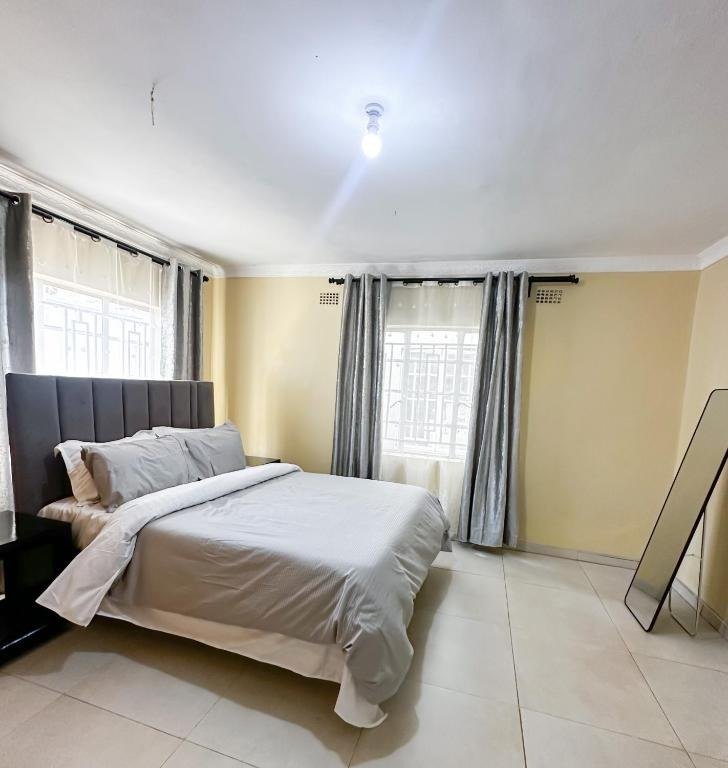 Main bedroom with double bed and full-length mirror