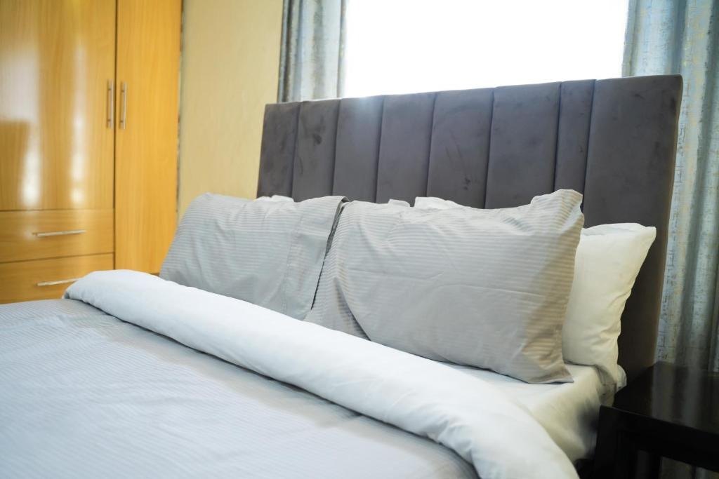 Bed with fresh linens and wardrobe