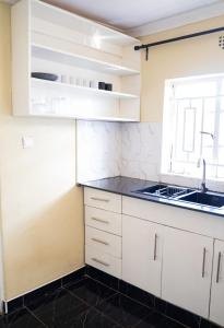 Kitchen with stovetop, sink and cabinets